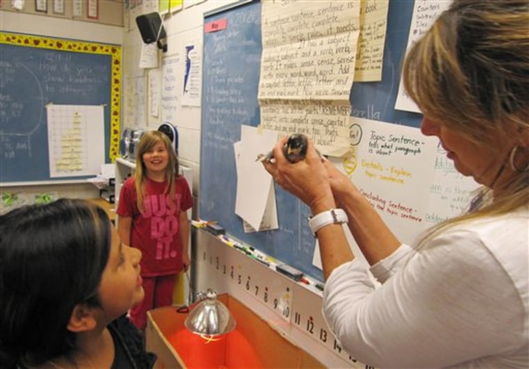In this photo taken May 9, 2012, Middleton Heights Elementary Principal Robin Gilbert holds a baby chick while visiting an all-girls classroom of first- and second-graders at her school in Middleton, Idaho. Middleton is believed to be the only public school in Idaho offering all-boy and all-girl classrooms, though the movement is widespread in other states and is now being targeted by the American Civil Liberties Union in a bitter struggle over whether single-gender learning should be continued. (AP Photo/Jessie L. Bonner)